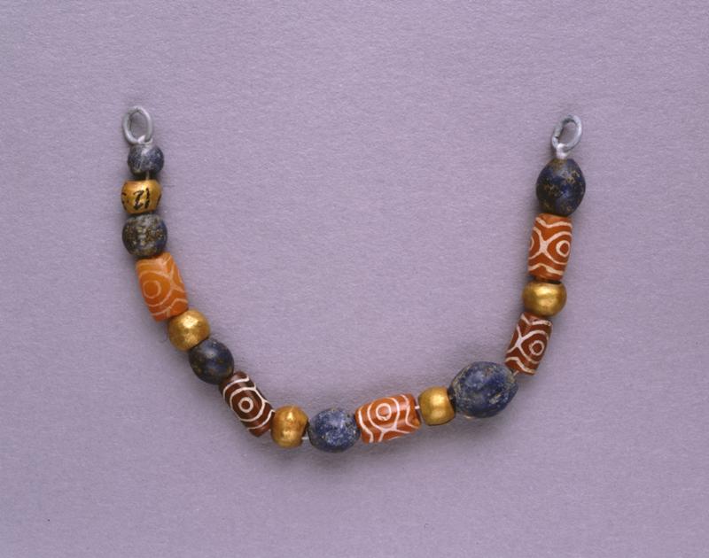 String of gold, carnelian, and lapis beads.