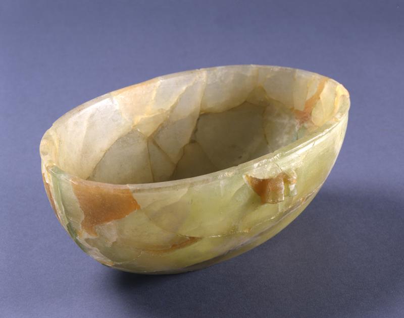 Bowl of translucent green calcite, oval, with knob handles.