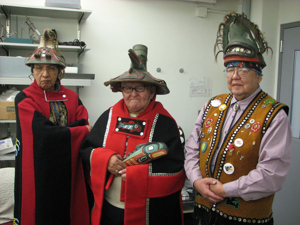 During a Tlingit consultation visit in January 2008, Andrew Gamble, Jr. (Kaagwaantaan clan leader), Herman Davis (L’ooknax. ádi clan leader), and Tom Young (Kaagwaantaan Box House leader) donned Tlingit clan regalia, including three hats in the Penn Museum’s collections. Photo by Robert W. Preucel.