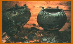 Two large vats or cauldrons