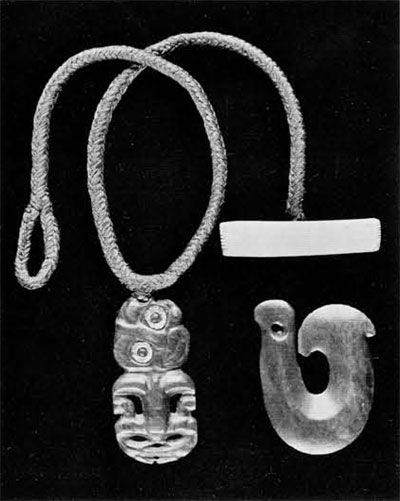 Two pendants of New Zealand jade carved by the Maori. The little man is usually referred to as a tiki; the fish shaped one is called hei matau.