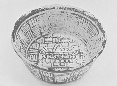 A bowl with geometric designs along the sides and a deity depicted on the bottom.