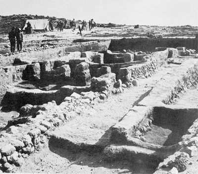 A north-south street of the 10th century city on the tell. To the left of the street doorways lead into the houses with pillars. One householder had faced the side of his mud-brick wall on the street with stones.