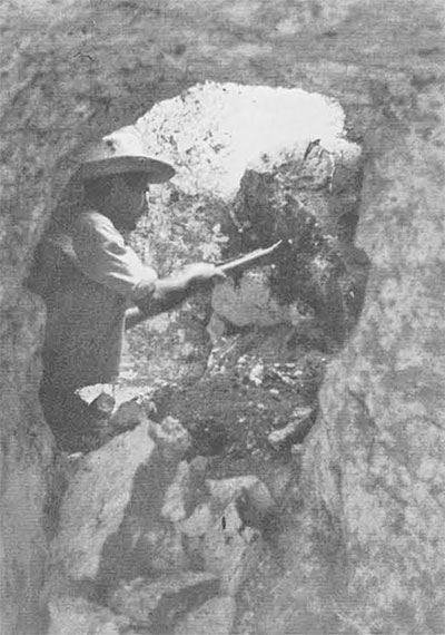 A workman digging inside a chultun. In rare cases the chambers are large enough to stand up in; the majority, however, are small, with little more than squatting room. 