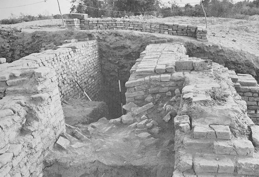 Two excavated brick walls, a deep gap between them.