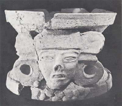 Incense burner in the shape of a head, supporting a plate.