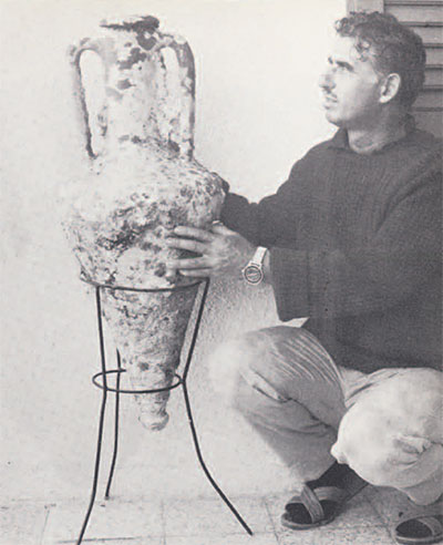 Andreas Cariolou admires the single amphora he raised upon "rediscovering" the Greek ship.