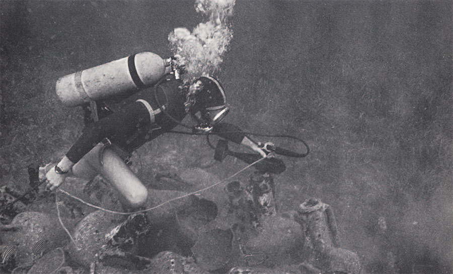 Diver places Dr. Hall's proton magnetometer over the wreck.