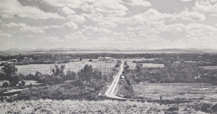 Our favorite road. We are looking south toward Fort Bridger, Wyoming, from the glacial terrace of Quarry Creek, over an unpaved section of the original Lincoln Highway which has been bypassed by later road construction. The Bridger Basin spreads back through most of the view, with the Black's Fork River in the foreground.