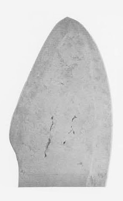 Close up of a knife tip showing beveled edges and crystaline structure of the material.