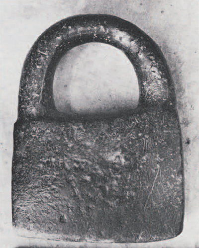 Steatite padlock-shaped object (about 2700 B.C.) reused in modern shrine. Originally a weight? Height, ca. 30 cm.