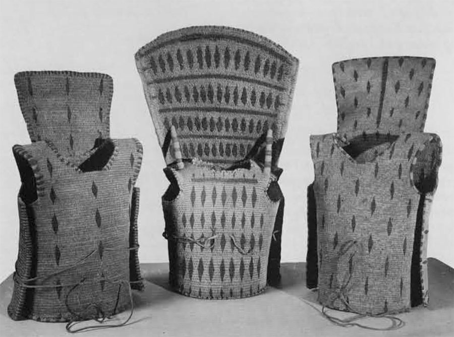 Robert Louis Stevenson's three Gilbert Island corselets (P3294 A,B,C). Heavy and rigid, these provided effective protection against sharks' teeth weapons, throwing spears, and European kinves and bayonets. They are made of horizontal bundels of coconut fiber, firmly bound together with twisted fiber cord. The high back of P3294B (center) is braced by two short sticks rising from the shoulders, and reinforced by two long sticks bound along the outside edges. The black diamonds and stripes on all three corslets are human hair. 