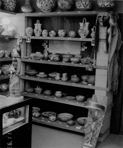 A bookcase full of Hopi pottery fro sale.