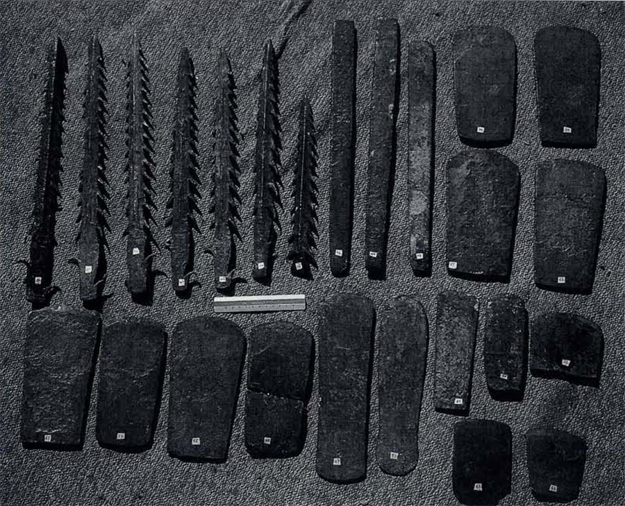 Metal hoard tools, including teethed harpoon points and rounded axe heads.