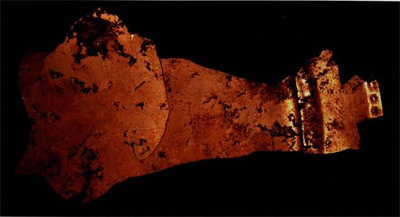Fig. 1. Fragment of depletion-gilded ornamental disk from Burial 25, Sitio Conte, Panama. Its golden sheen effectively conceals that it is not made of pure gold but of an alloy called tumbaga. This piece has been found to be 75.5% gold, 21.1% copper, and 3.4% silver (a common contaminant of South American gold). Museum Object Number: 40-13-196