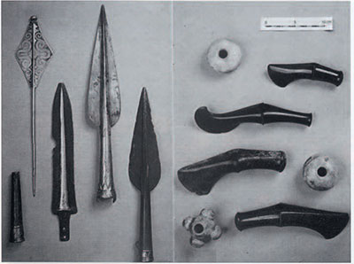 A display of spears, daggers, maces, and stone axes.