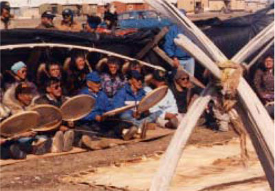 Successful Iñupiat hunters drum and sing in the shelter of their whaling boats whaling boats 