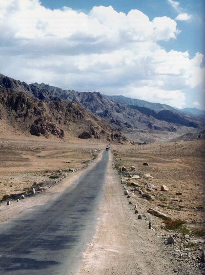 A road in Northern India in the Ladakh Region, mountains in the distance.
