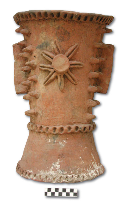 Throughout the Maya area, censers display spiky protrusions. These protrusions likely represent the spikes on the trunks of young ceiba trees. This censer contained a burnt corn cob and several burnt grains of corn. UPM # NA 11370; 39.3 cm tall.