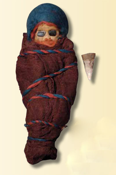 Mummified remains of an infant swaddled in red cloth and a red and blue rope.