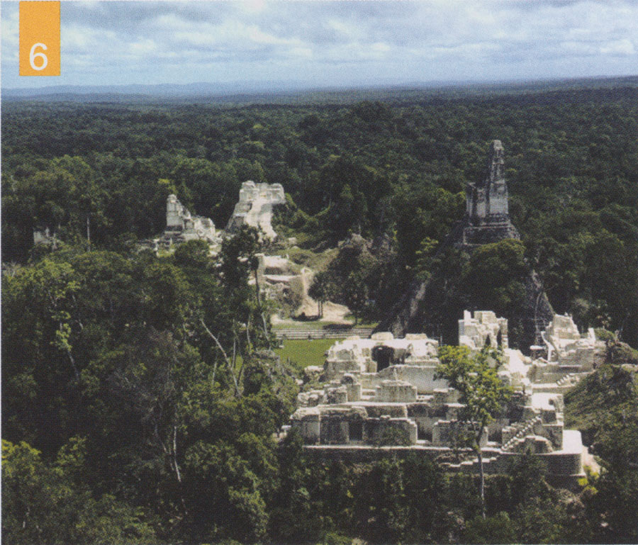 Aerial view of Tikal ruins rising out of the rainforest.