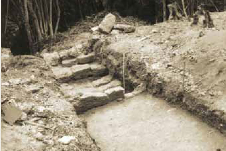 This 1962 photograph of the excavation of the kitchen foundation walls looks south. The reservoir ravine, here filled with dense vegetation, lies beyond the kitchen.