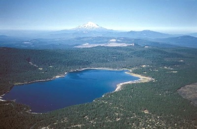 Medicine Lake, aerial view with Mount Shasta in the background. Medicine Lake Highlands is a sacred place of ceremony and healing for the Pit River, Modoc, Shasta, Karuk, Wintu, and other tribes in northern California. Geothermal development threatens the area and energy companies have sought permits from the U.S. Bureau of Land Management and Forest Service, which the Pit River Tribe and others have challenged for failure to undertake adequate environmental review and tribal consultation; the federal courts have agreed so far in ongoing litigation and administrative proceedings. Hatchet and Bunchgrass Mountains, and the surrounding lands in traditional Pit River Indian Territory, are also in jeopardy from 49 planned windmill turbines and related roads and facilities in the heart of this region. Photo courtesy Julie Donnelly-Nolan, US Geological Survey, 2000.