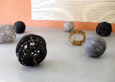 Spirit Balls, 7 Spheres (2010). 40" x 15' x 15", horsehair, dirt, rubber tires, bicycle inner tubes, sticks, and bicycle wheels.