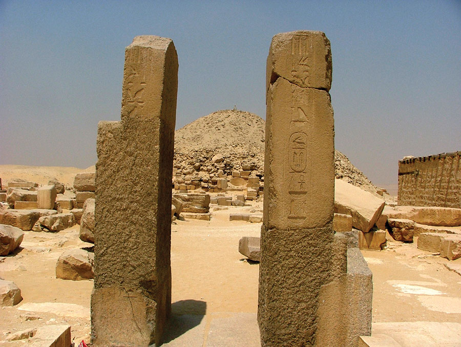 Pillars, naming the king Unas, flank the causeway leading to the dilapidated superstructure of the king’s pyramid tomb at Saqqara. Photo by Joshua A. Roberson.