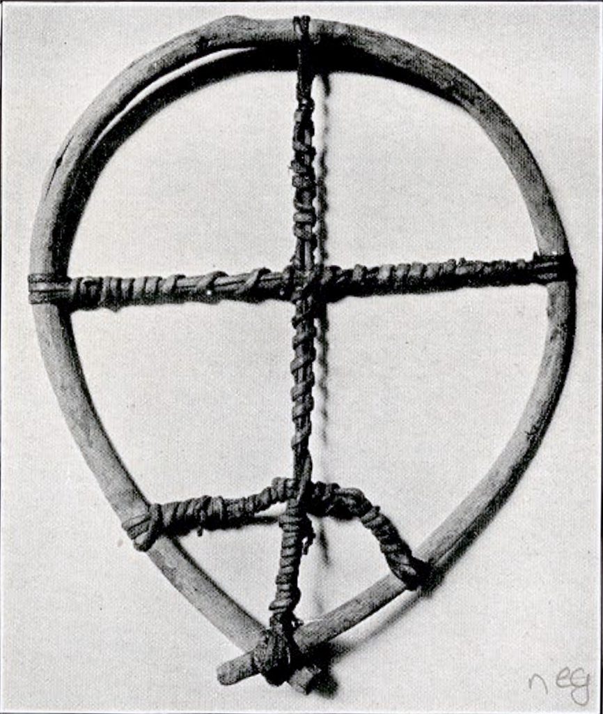 A round snowshoe with one vertical crossbar and two horizontal ones