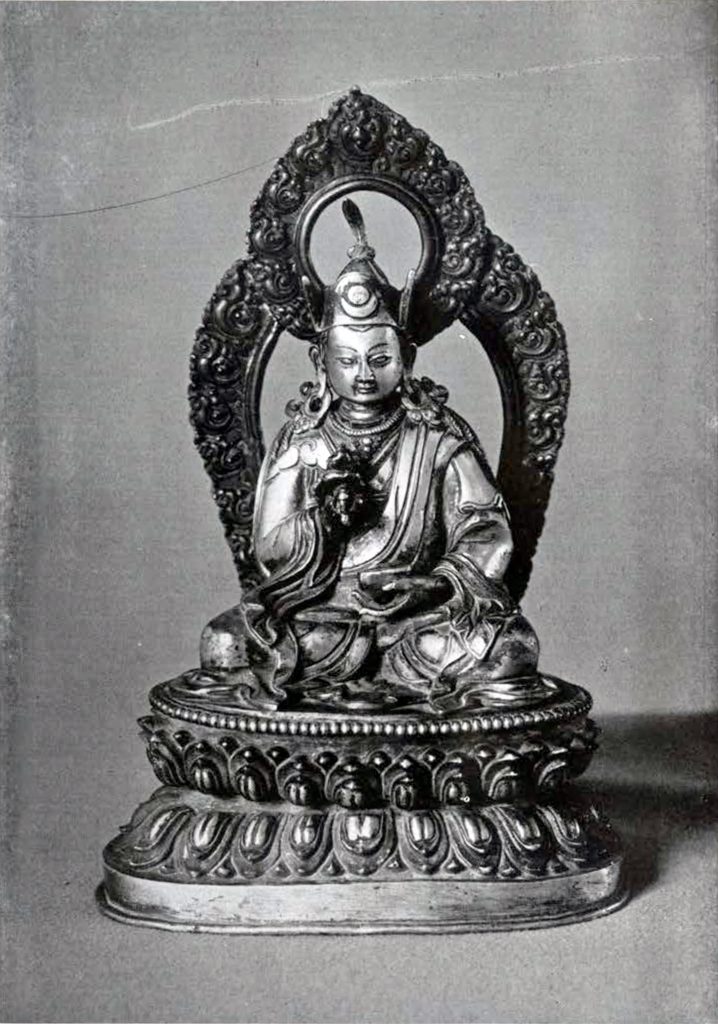 Gilded bronze statuette of Padmasambhava, wearing a hat or crown, on a double lotus base with a halo