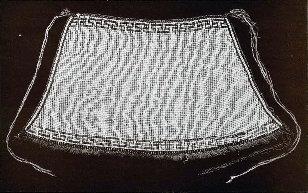 A beaded apron with a small pattern along the top and bottom edge