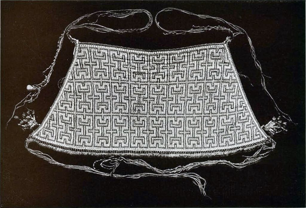 A beaded apron with repeated bands of pattern