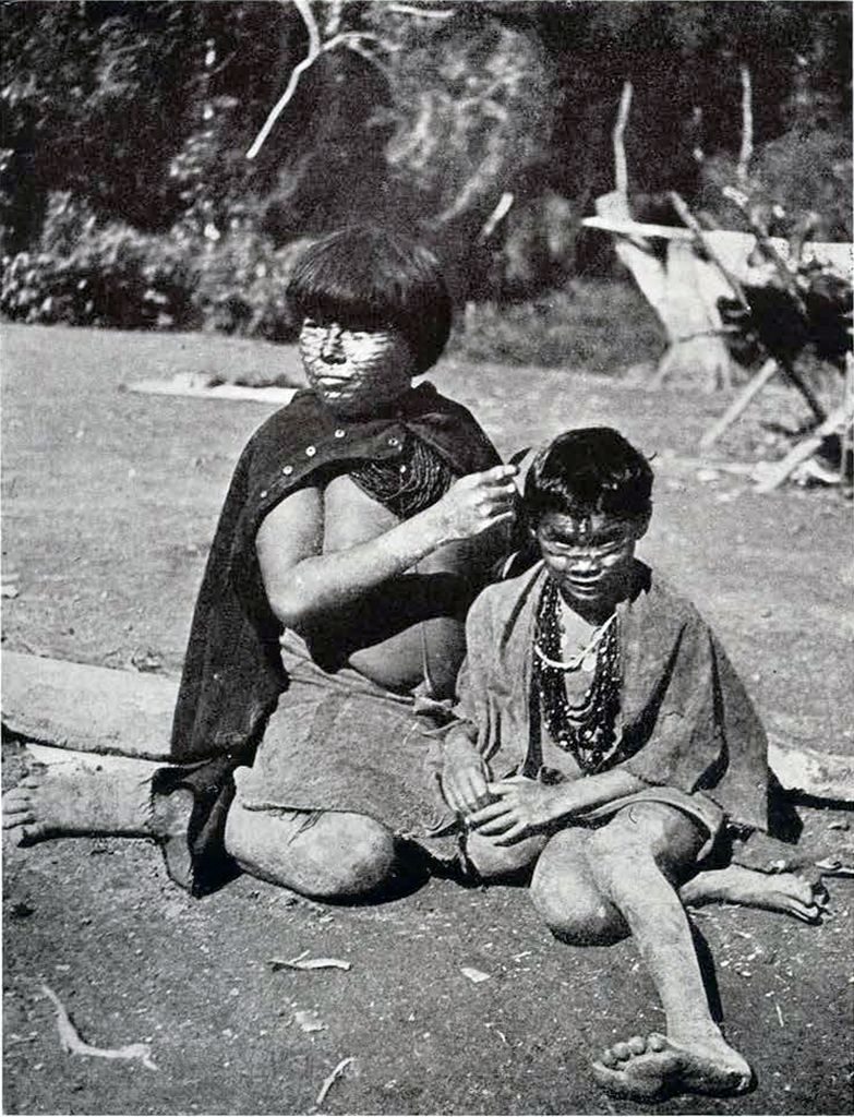 A Macoa woman picking lice out of another's hair