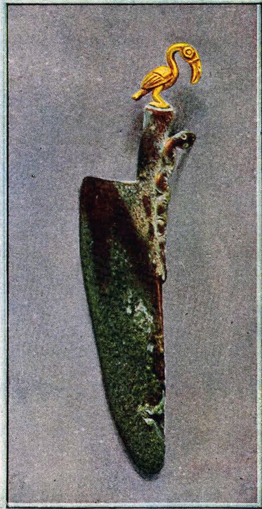 Colored image of an oxidized bronze knife with told snake and bird on the handle