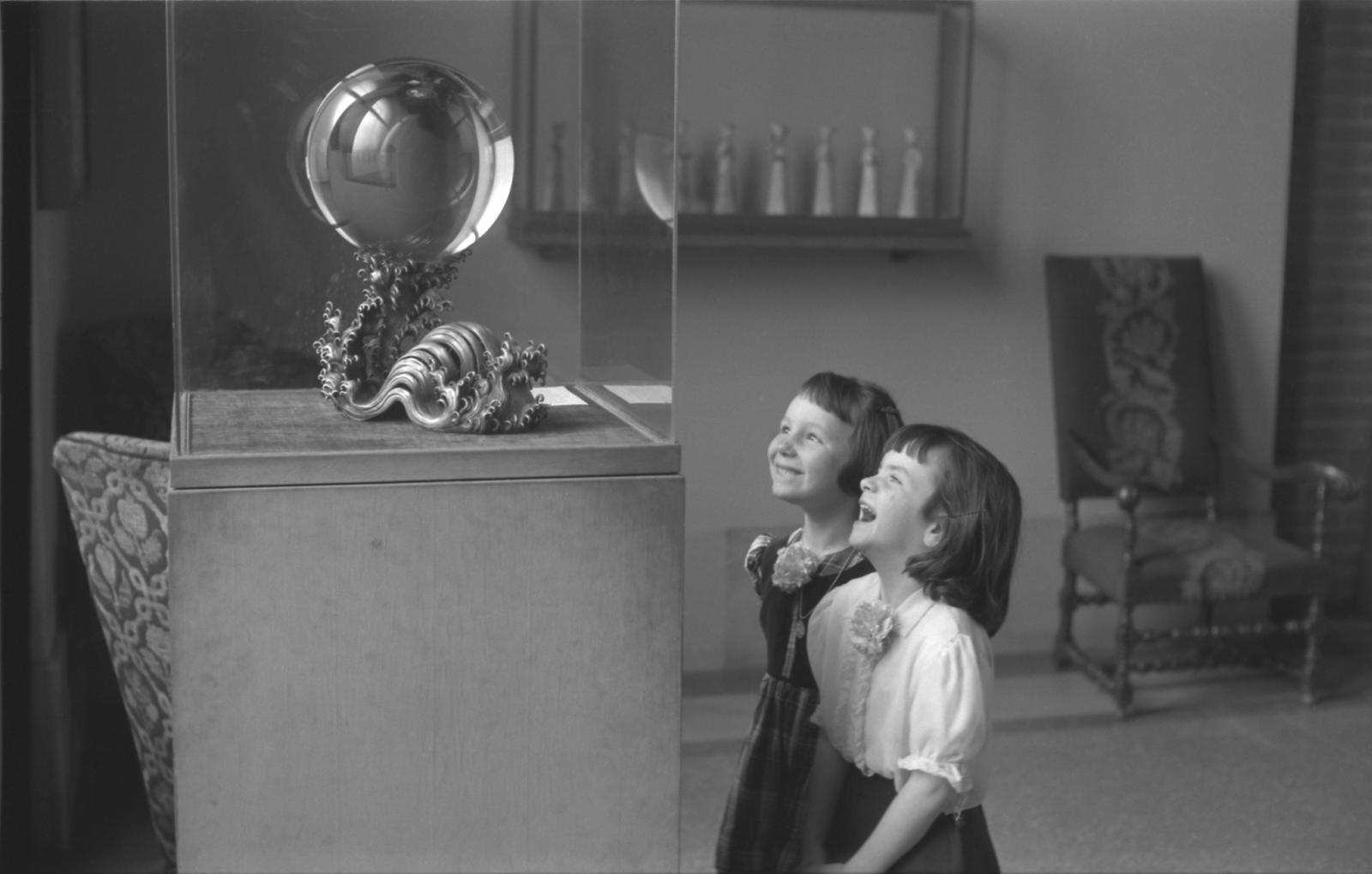 Two children marvelling at the crystal ball.