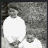 Two Tlingit children together in undergrowth. Summer 1917. Haines. Alaska.
