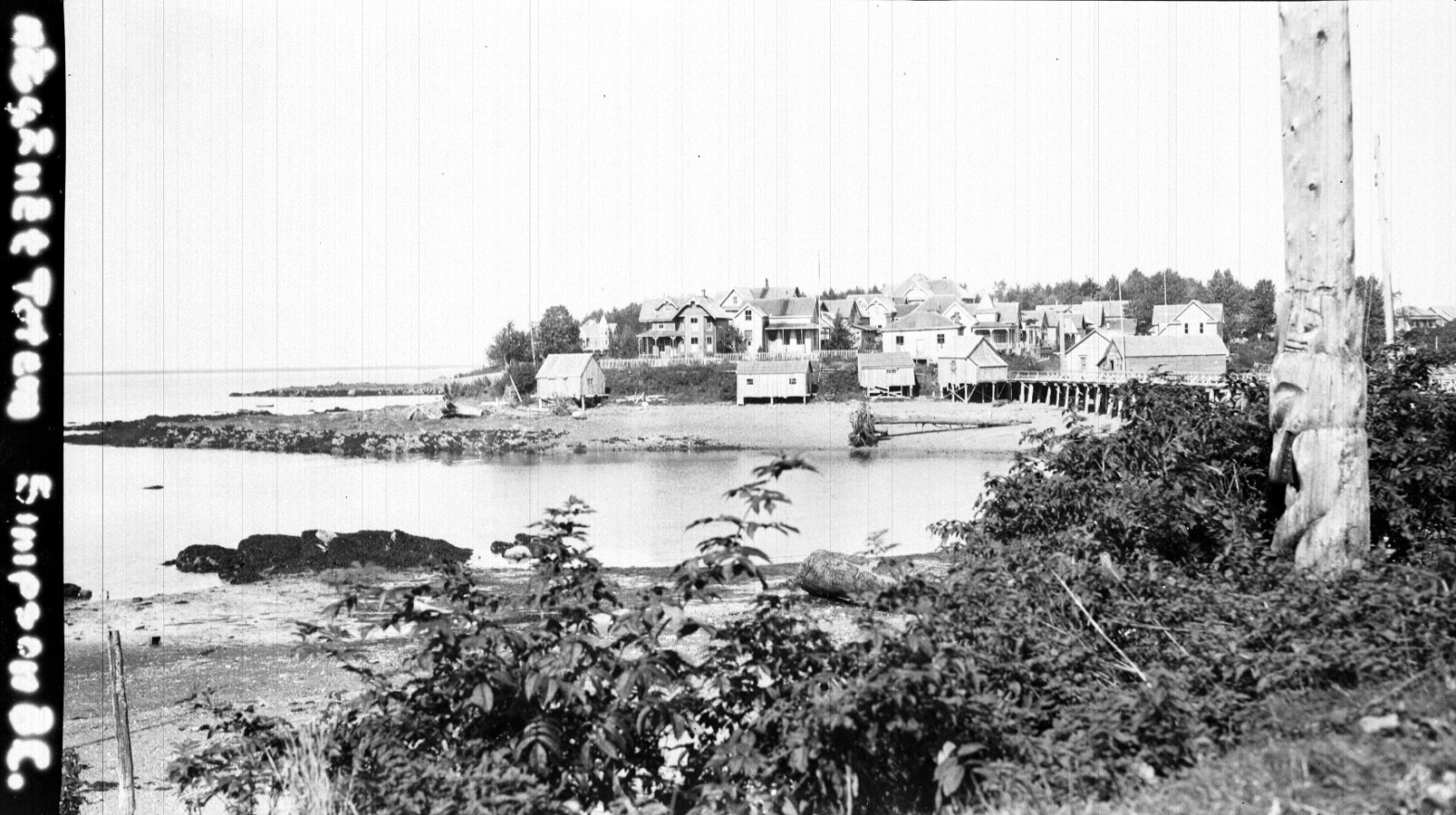 Port Simpson, B.C. Island section. Totem pole in foreground. Aug. 31, 1918