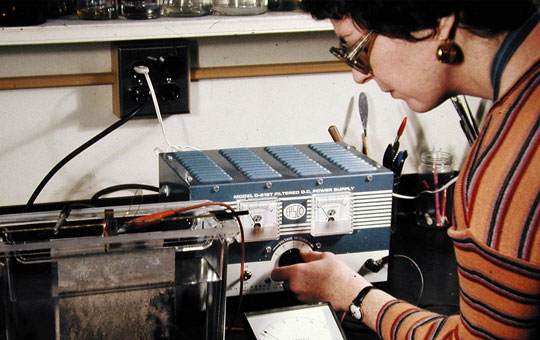 Woman operating machinery in a lab.