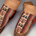 Embroidered boots with gradated colors, ca 2nd - 3rd century CE. Excavated from Tomb No. 5 of Cemetery No. 1, Niya, Xinjiang Uygur Autonomous Region, China. © Xinjiang Uygur Autonomous Region Museum.