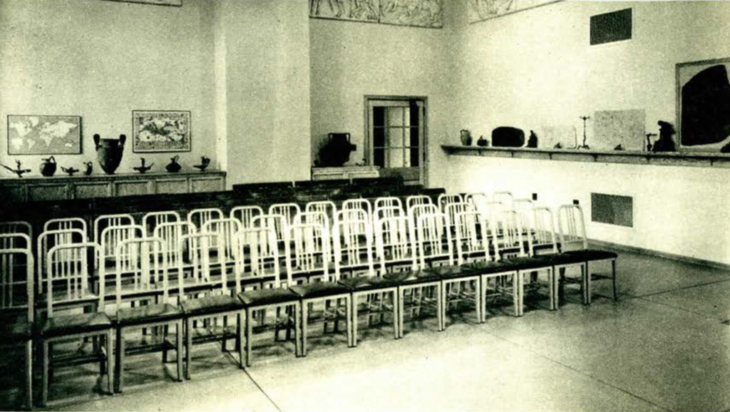 An empty classroom with rows of chairs