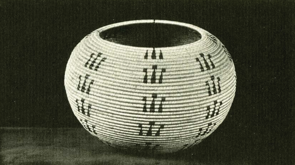 Small round woven basket with columns of three black marks