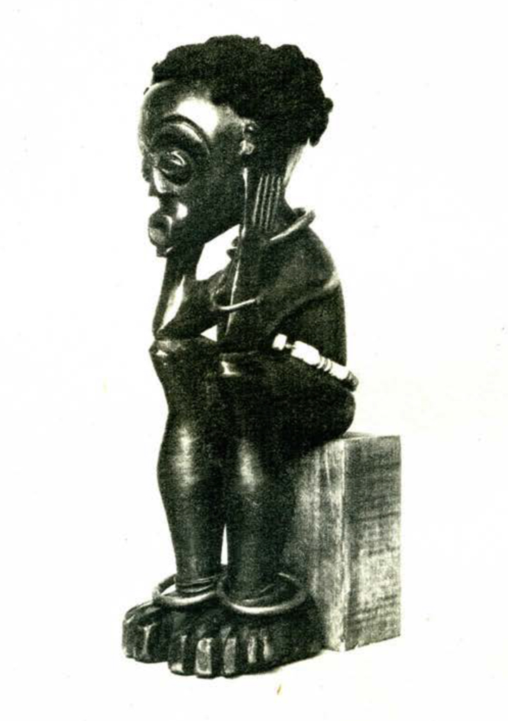 Wood figurine of a squatting woman with her head in her hands, wearing a beaded belt and jewelry