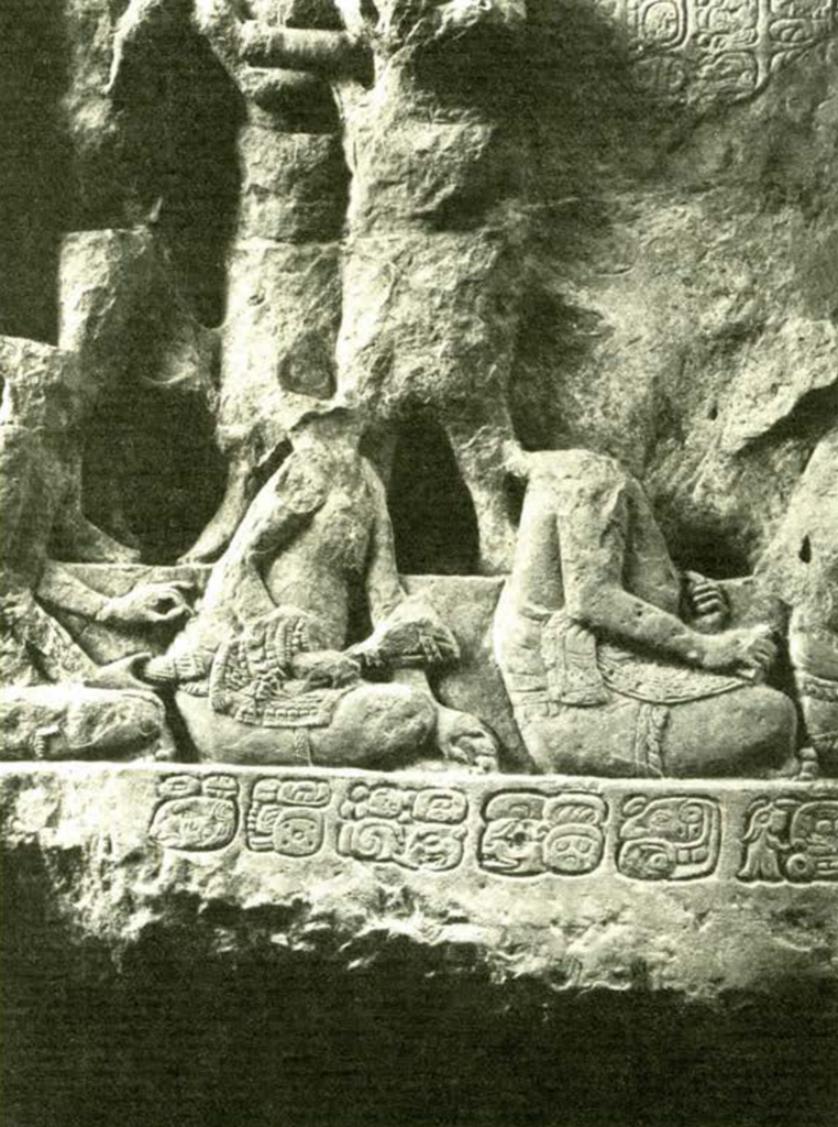 Close up of a stone lintel showing seated figures