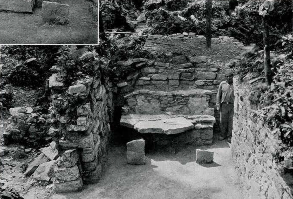 View of a stone throne cleaned up and pieces added, a man standing next to it