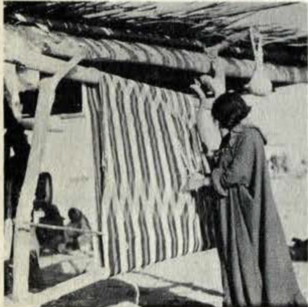 A woman weaving a vertical pattern on a wooden loom