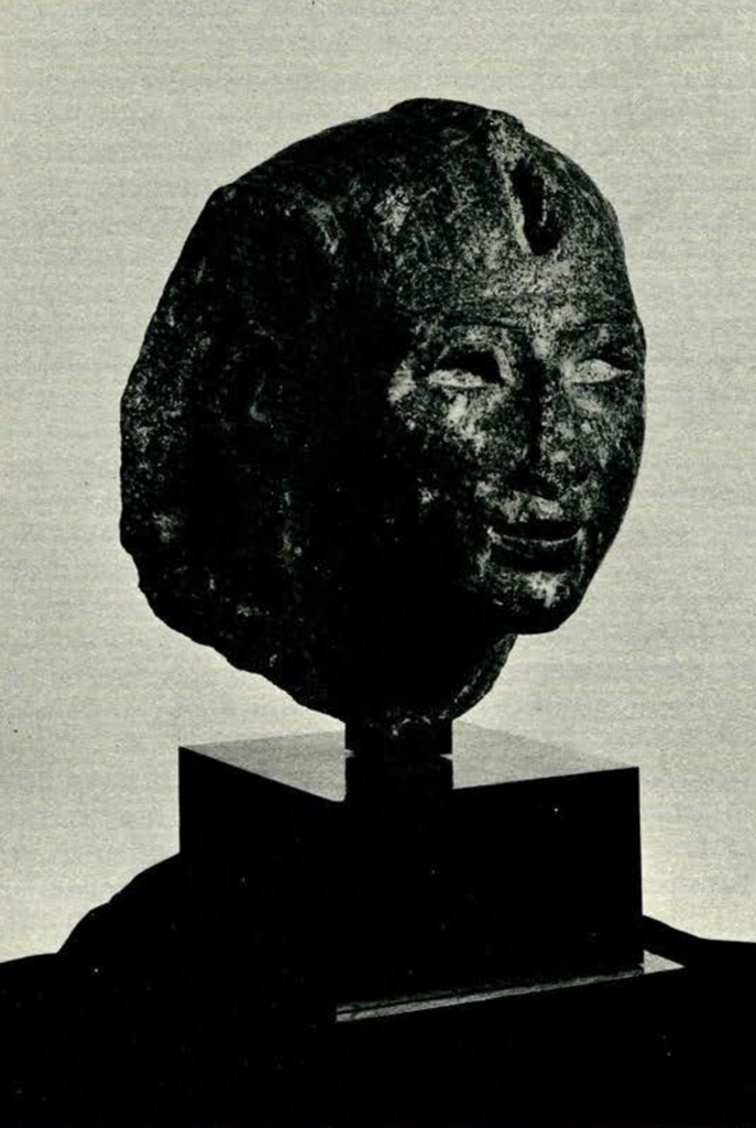 Head from a statue of a Egyptian king wearing a headdress with pieces missing, 3/4 view