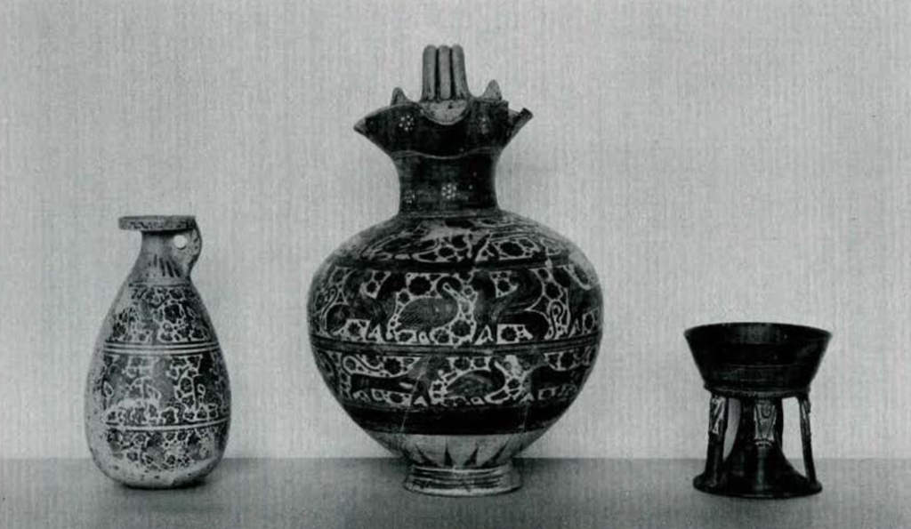 Two pitchers and a stand, the two pitchers decorated with animals in three registers