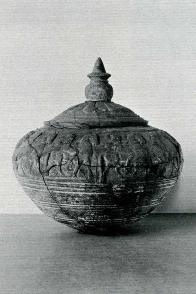 Ornate vessel with frieze of figures, and a decorated lid