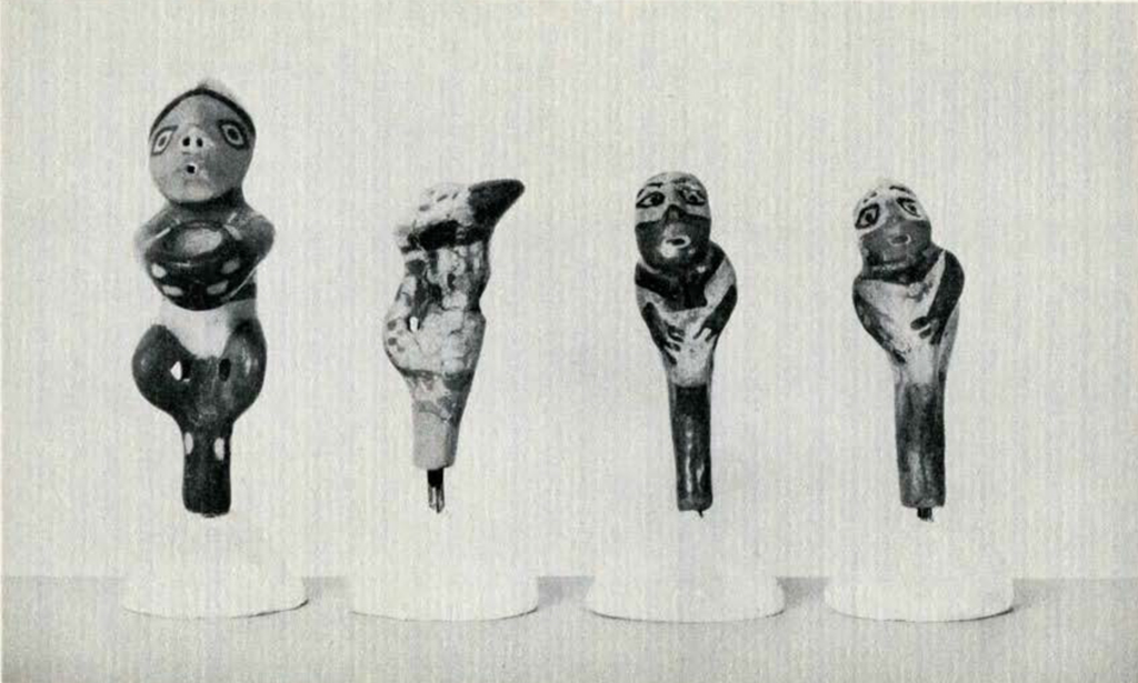Four pottery whistles in the shape of human figures